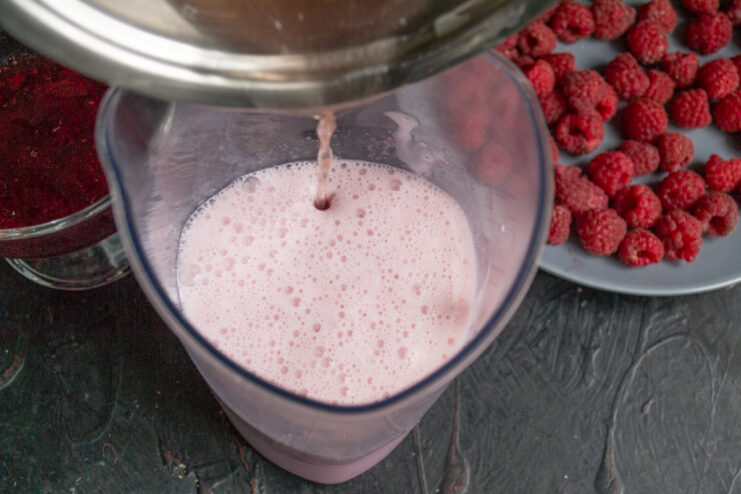 Combining the Layers Pouring a thin stream of dissolved gelatin into foamy pink milk