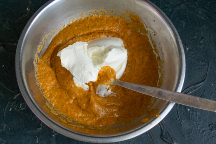 Adding the Cream Cheese Folding soft cream cheese into the puréed zucchini mixture