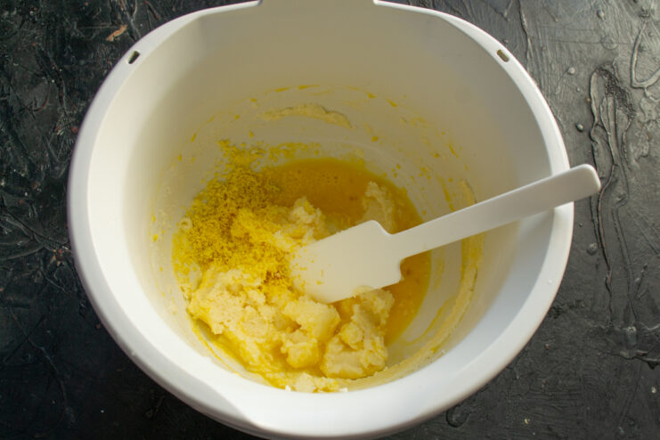 Egg base for the dough Adding a raw egg and crumbled hard-boiled yolk to the butter mixture