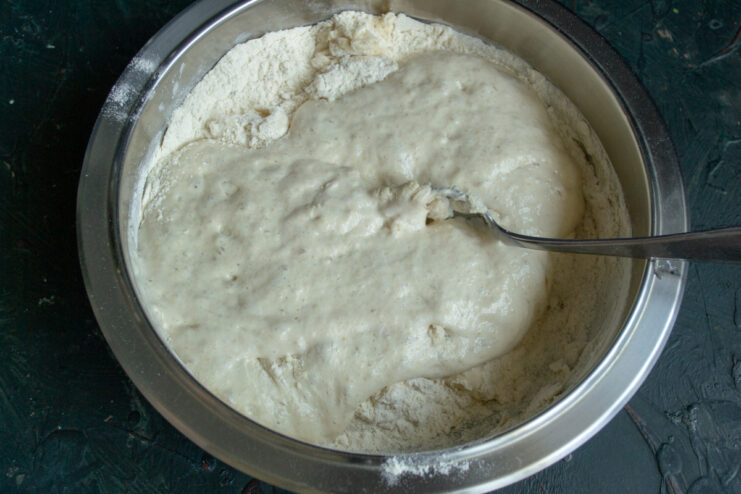 Mixing the ingredients Adding active sourdough starter to the flour mixture