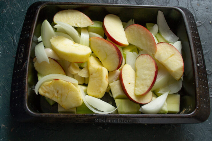 Incorporating apples Thick apple wedges arranged over vegetables for roasting