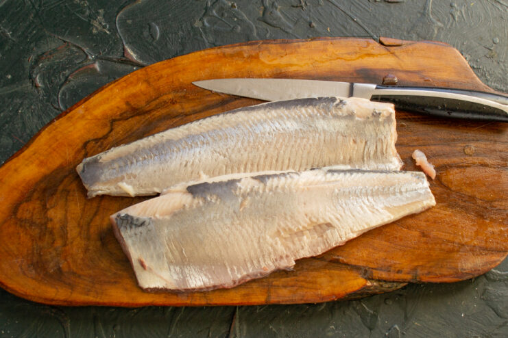 Cleaned herring fillets Herring fillets peeled and deboned on a cutting board