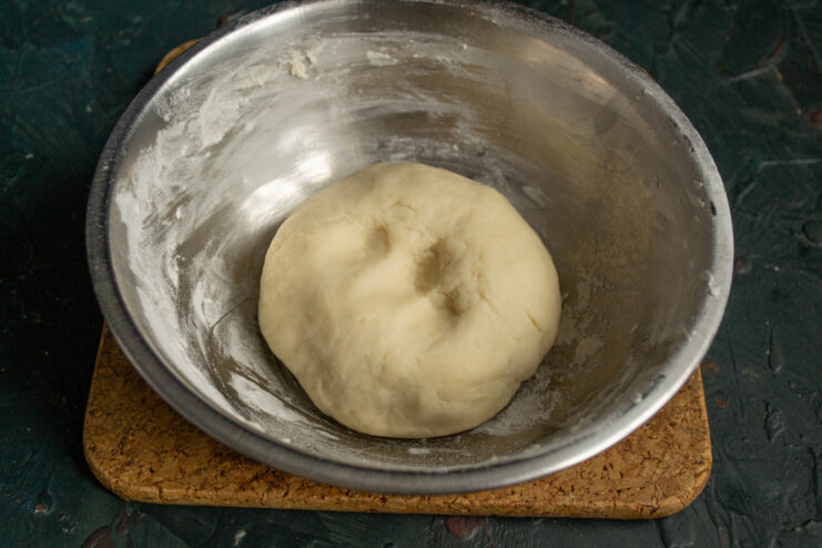Smooth ball of dough resting in a bowl