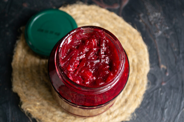 Filling the jars Hot beet borsch base tightly packed into a glass canning jar.