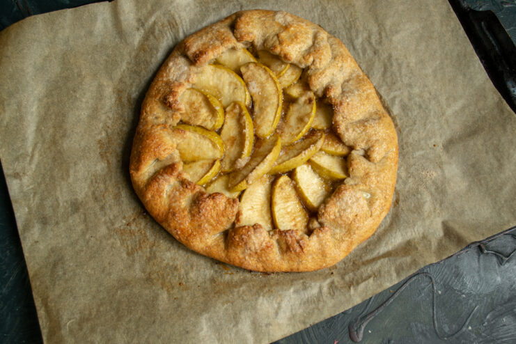 Baking the Galette Baked golden brown apple galette on a baking sheet in the oven