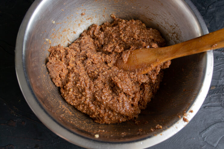 Finished chocolate mixture Thick, pliable chocolate mixture for sweet salami in a metal mixing bowl