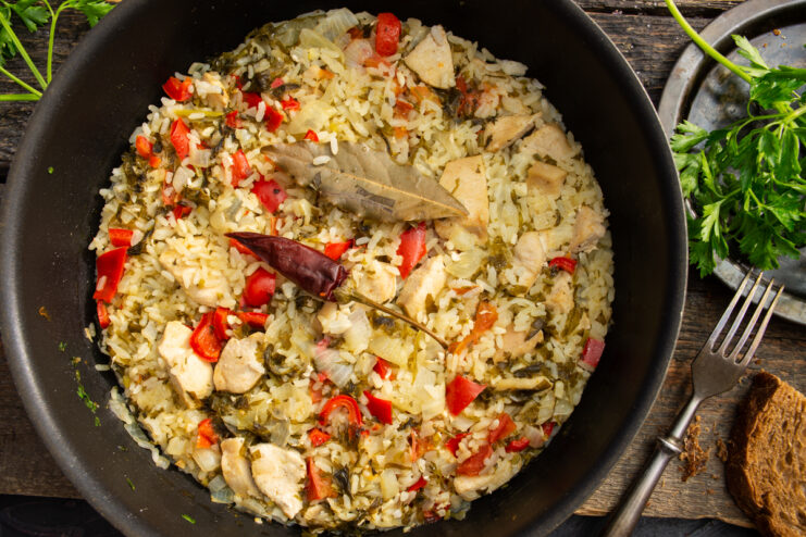 Finished chicken breast with rice and vegetables served in a deep skillet