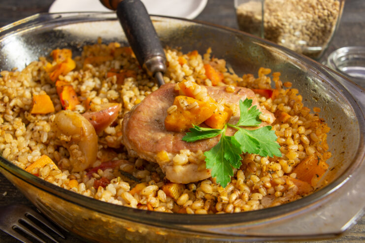 Finished farro with meat and pumpkin in a baking dish