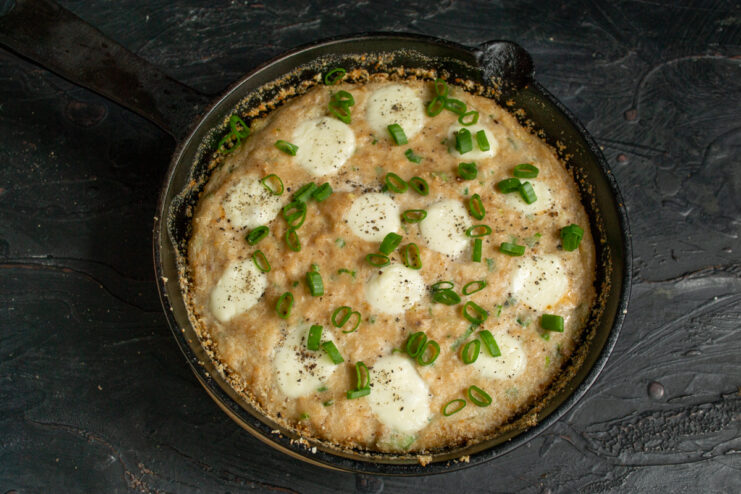 Serving the dish Finished fish casserole topped with chopped green onions and black pepper.