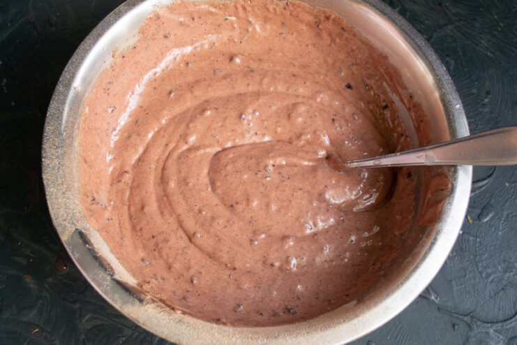 Mixing The Cake Batter Thick dark chocolate and blackcurrant cake batter in a mixing bowl