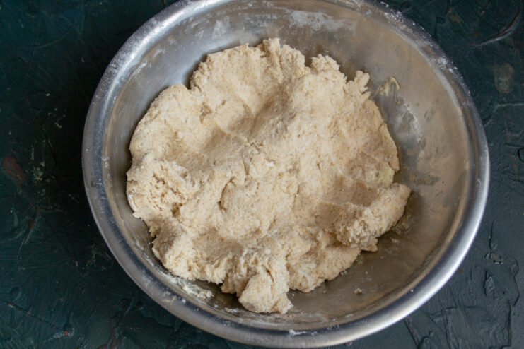 Thick mixed dough resting in a bowl