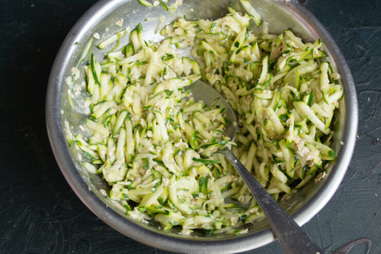 Resting the batter Thickened zucchini and oat batter resting in a bowl.