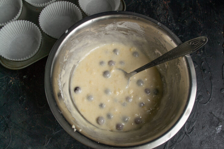 Prepared muffin batter resting in a metal bowl