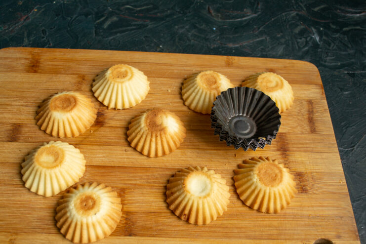 Cooling the baked pastry shells Finished shortcrust pastry shells removed from molds and cooling on a board