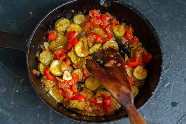 Simmering the Vegetables Fully tender stewed vegetables simmering in a skillet