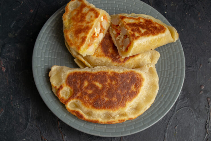 Serving the pan-fried hand pies Finished golden-brown pan-fried hand pies served on a gray plate