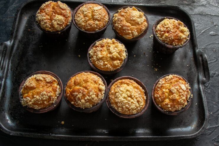 Checking muffins for doneness Freshly baked golden muffins resting in a baking pan