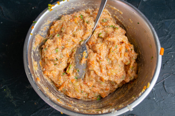 Thick seasoned ground fish mixture in a metal bowl