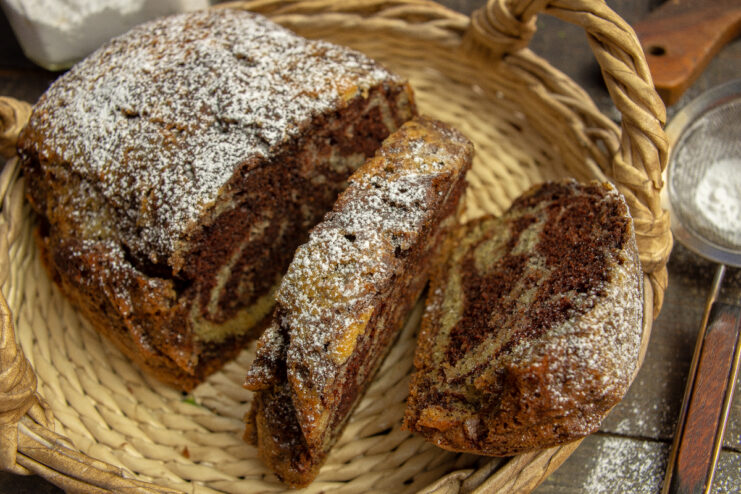 Baked Zebra cake dusted with powdered sugar sitting in a woven basket