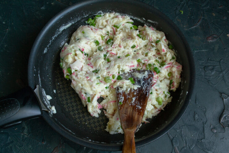 Mixing the crab filling Thick and glossy crab filling in a skillet ready for shaping