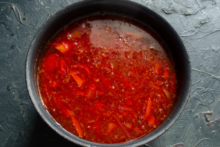 Finalizing the borscht flavor Finished red borscht inside a pot after stirring