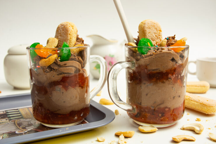 Finished chocolate ricotta cream with jam served in clear glass mugs.