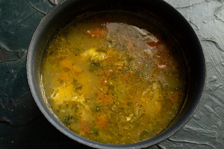Resting the soup Finished rich cod and mussel soup resting in a cooking pot
