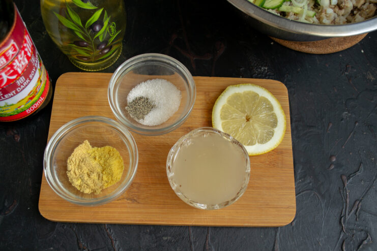 Ingredients for the dressing Ingredients for homemade mayonnaise arranged on a wooden cutting board