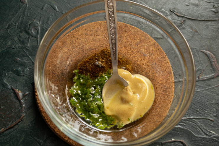 Preparing Zesty Dressing Dressing ingredients including mustard spices and garlic in a bowl
