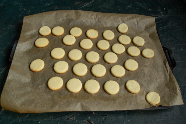 Baked Cookies on Baking Sheet Freshly baked golden shortbread cookies resting on a baking sheet