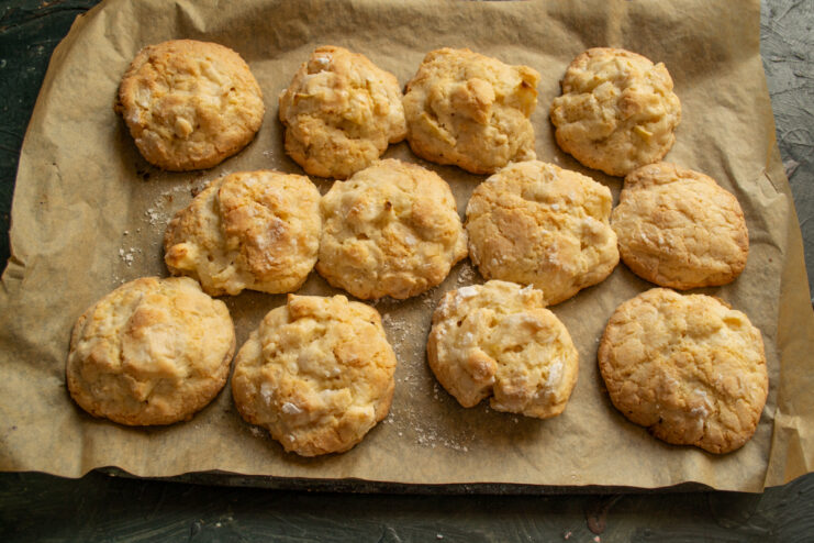 Baking until golden brown Freshly baked golden scones resting on parchment paper