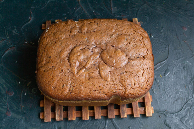 Baked Berry Sponge Cake Freshly baked dark sponge cake cooling on a wooden board