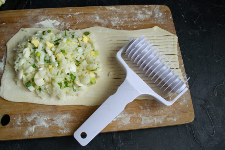Using a lattice roller cutter on a sheet of pastry dough