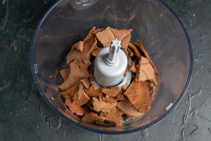 Crushing the baked chocolate shortbread in a blender bowl.