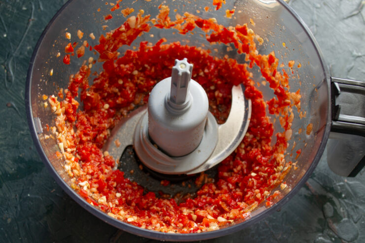 Blending the Raw Adjika Smooth and blended raw adjika paste inside a food processor bowl.