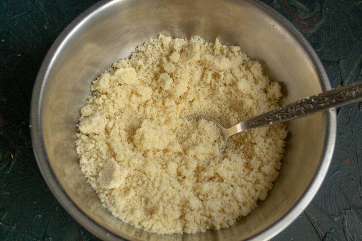 Finely ground almond flour gathered in a metal mixing bowl