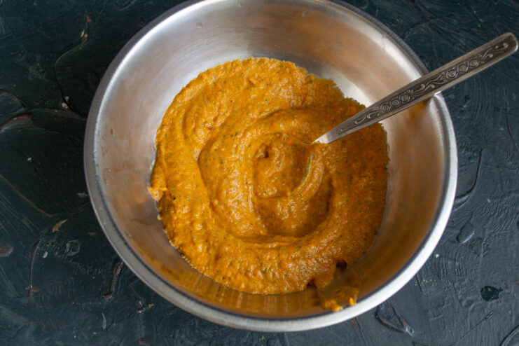 Puréeing the Vegetables Puréeing cooked vegetables with an immersion blender in a metal bowl