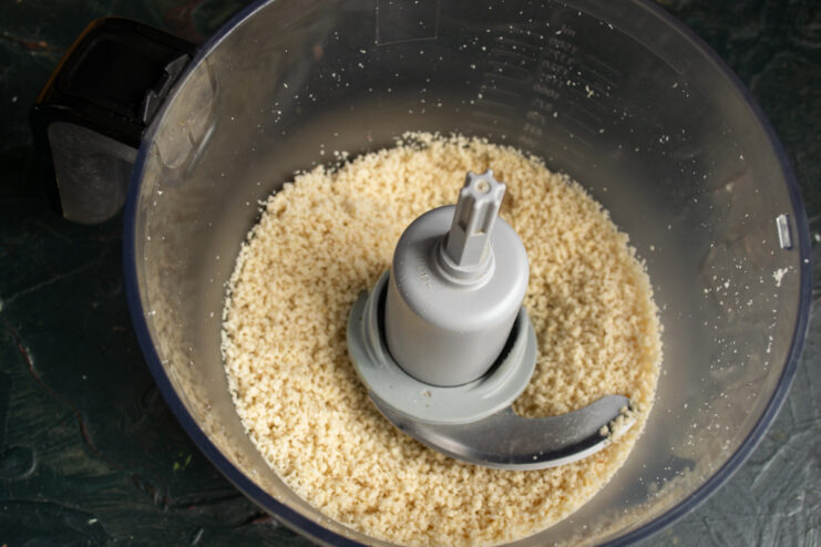 Grinding the peanuts Finely chopped peanuts inside a blender pitcher