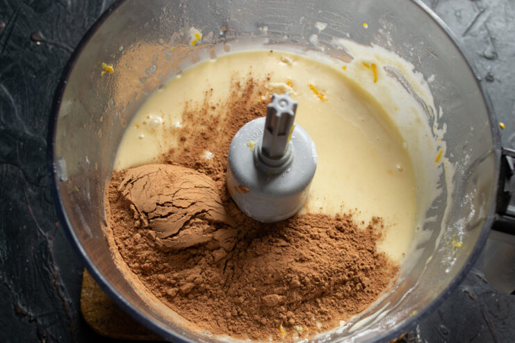 Adding cocoa powder Pouring cocoa powder into the cake batter
