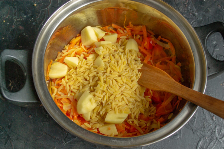Potatoes and risoni pasta Diced potatoes and risoni pasta added to the sautéed vegetable base