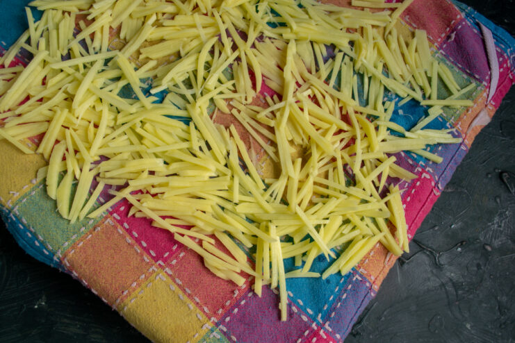 Drying the potato strips Shoestring potatoes drying on a kitchen towel