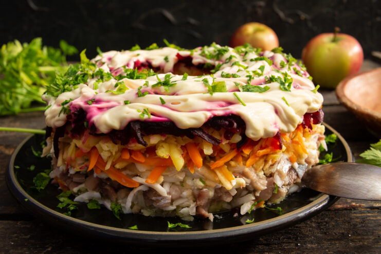 Classic Shuba salad with apple and herring plated in a festive ring shape