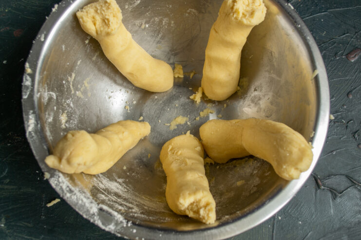 Preparing for freezing Small logs of dough placed in a container for freezing