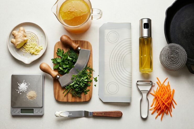 Assorted supplementary kitchen tools Collage of additional kitchen tools including a micro scale, mezzaluna knife, and a silicone baking mat.