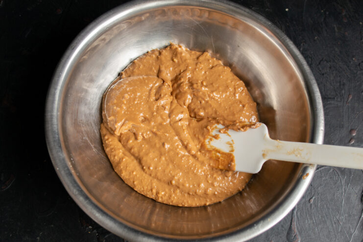 Chilling the mixture Candy mixture in a metal bowl with a spatula.