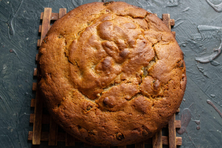 Baked cake cooling on a wooden cooling rack