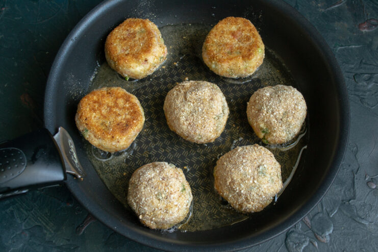 Frying until golden brown Crab croquettes frying in hot oil in a skillet