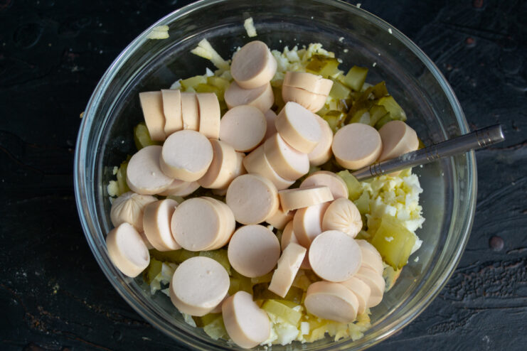 Slicing sausages Sliced sausage rounds in a salad bowl.
