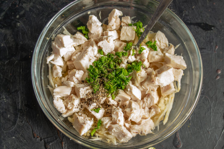 Adding parsley and black pepper Chicken and celeriac topped with chopped fresh parsley and black pepper
