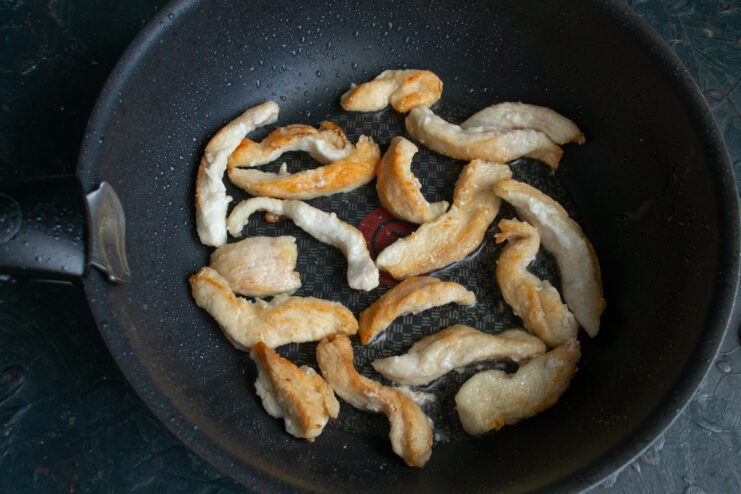 Frying the coated chicken Chicken pieces frying in a wok